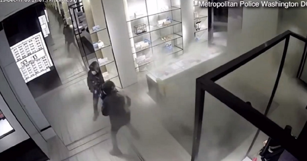 Surveillance video captures a thief using a fire extinguisher to rob a high-end store in Washington, D.C., Dec. 17.
