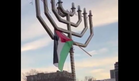 A Palestinian flag is seen on top of a menorah at Yale University.