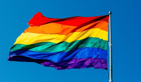 The LGBT flag flies in the above stock image.