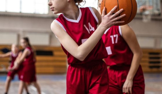 This stock image shows girls playing basketball.