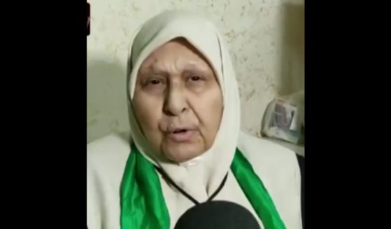 The mother of a Hamas terrorist speaks with a reporter.