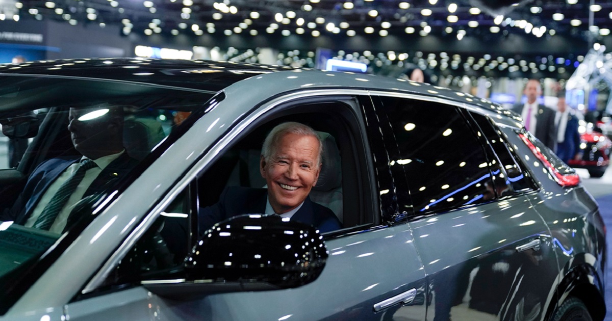President Joe Biden behind the wheel of a Cadillac Lyriq, an electric vehicle, in a showroom during a tour at the Detroit Auto Show in September 2022.