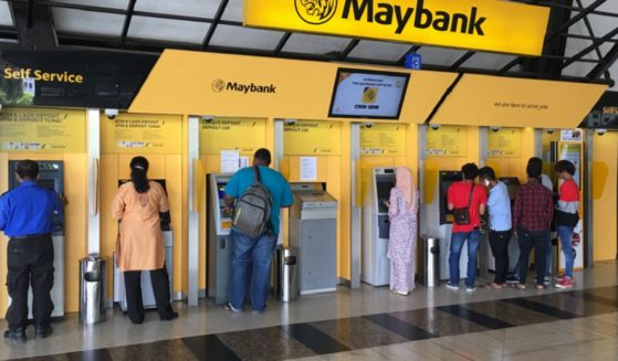Maybank customers use the banks ATMs outside the corporate headquarters in Kuala Lumpur, Malaysia, in a 2018 file photo.