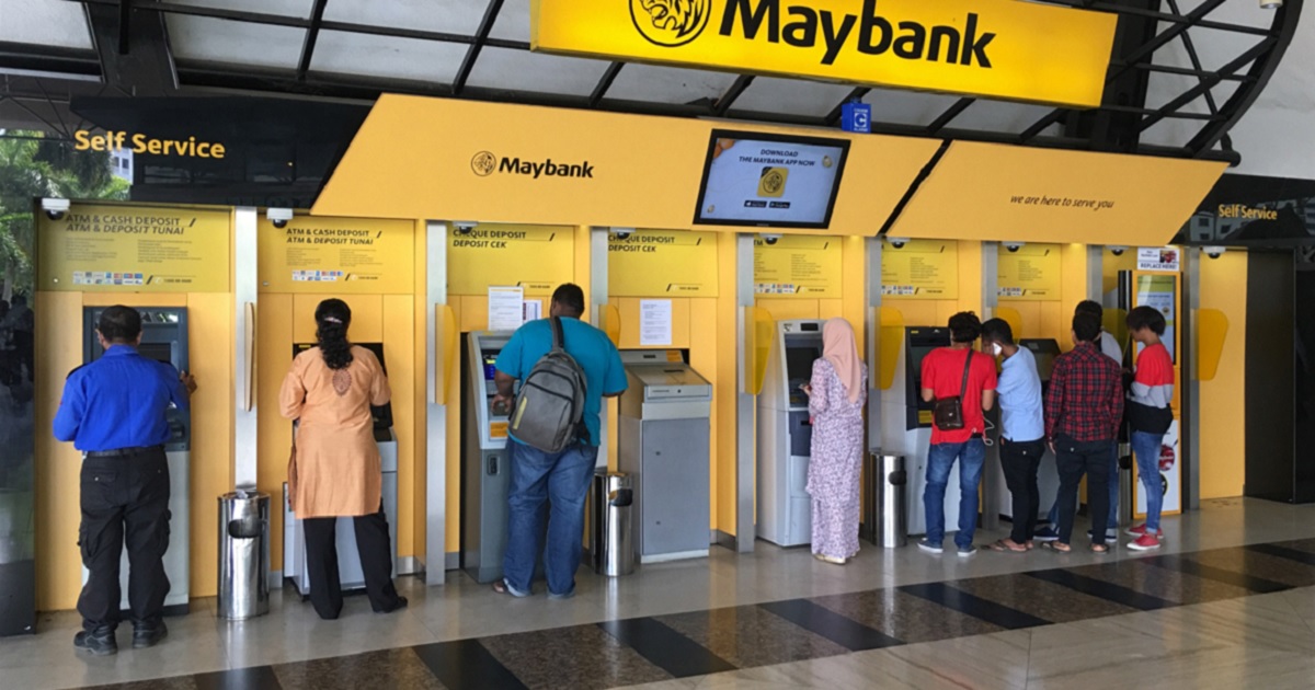 Maybank customers use the banks ATMs outside the corporate headquarters in Kuala Lumpur, Malaysia, in a 2018 file photo.