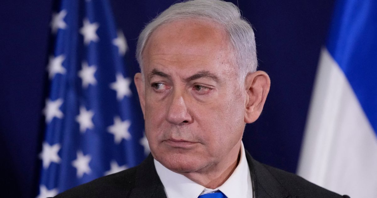 Israeli Prime Minister Benjamin Netanyahu looks on as the US Secretary of State gives statements to the media inside The Kirya, which houses the Israeli Defence Ministry, after their meeting in Tel Aviv on Oct. 12.