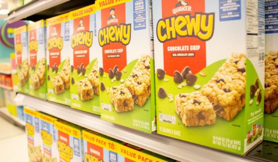 Quaker granola bars are seen on a store shelf in the above stock image.