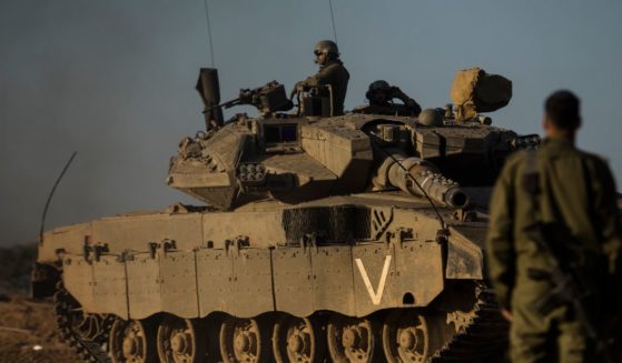 An Israeli soldier looks at a tank near the border with the Gaza Strip on Tuesday.