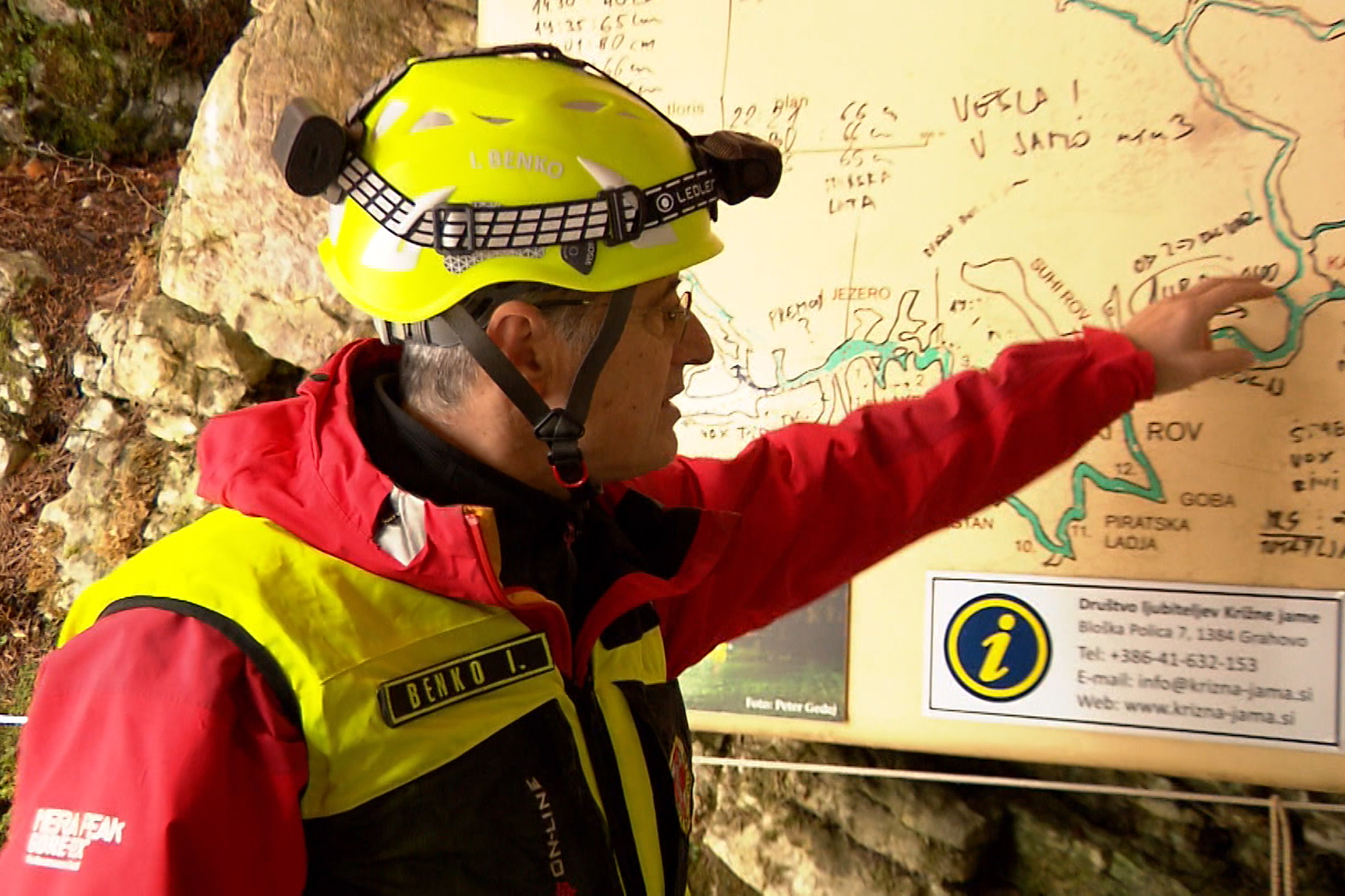 A rescuer inspects the map of Krizna Jama cave near Grahovo, Slovenia, on Sunday. Five people have been trapped in the cave since Saturday.