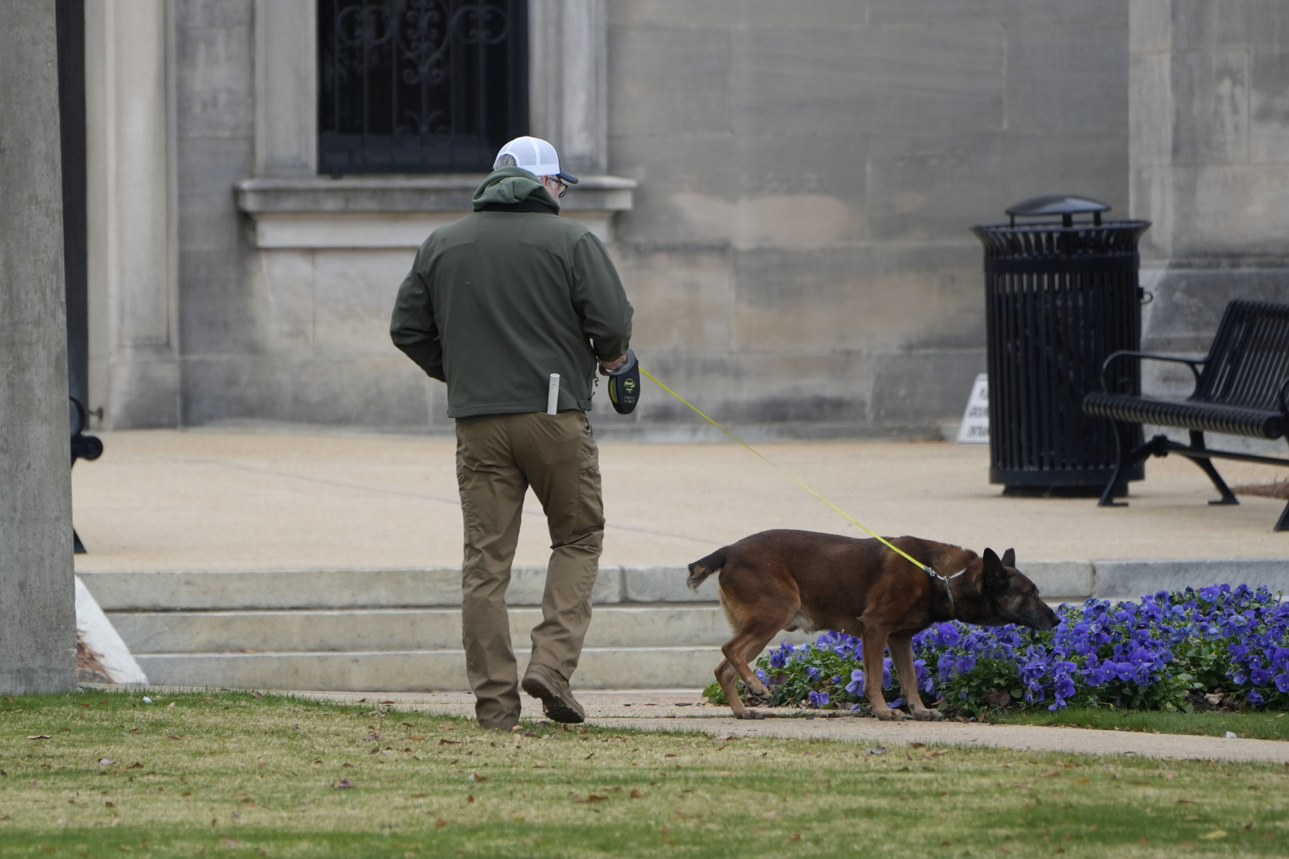 An ordinance sniffing dog patrols the grounds of the Mississippi State Capitol in Jackson, Mississippi, on Wednesday, following a bomb threat. At least six state Capitols were evacuated on Wednesday as the result of threats.
