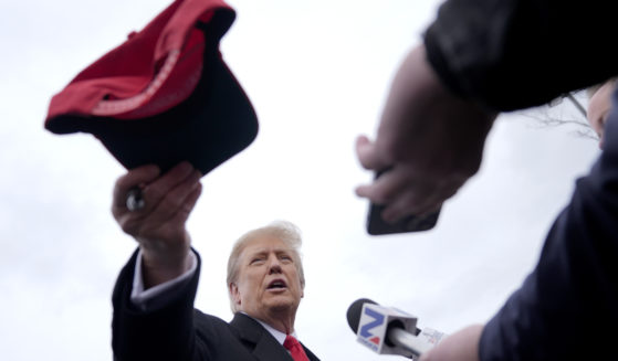Republican presidential candidate former President Donald Trump hands off a signed hat during a campaign stop in Londonderry, New Hampshire, on Tuesday.