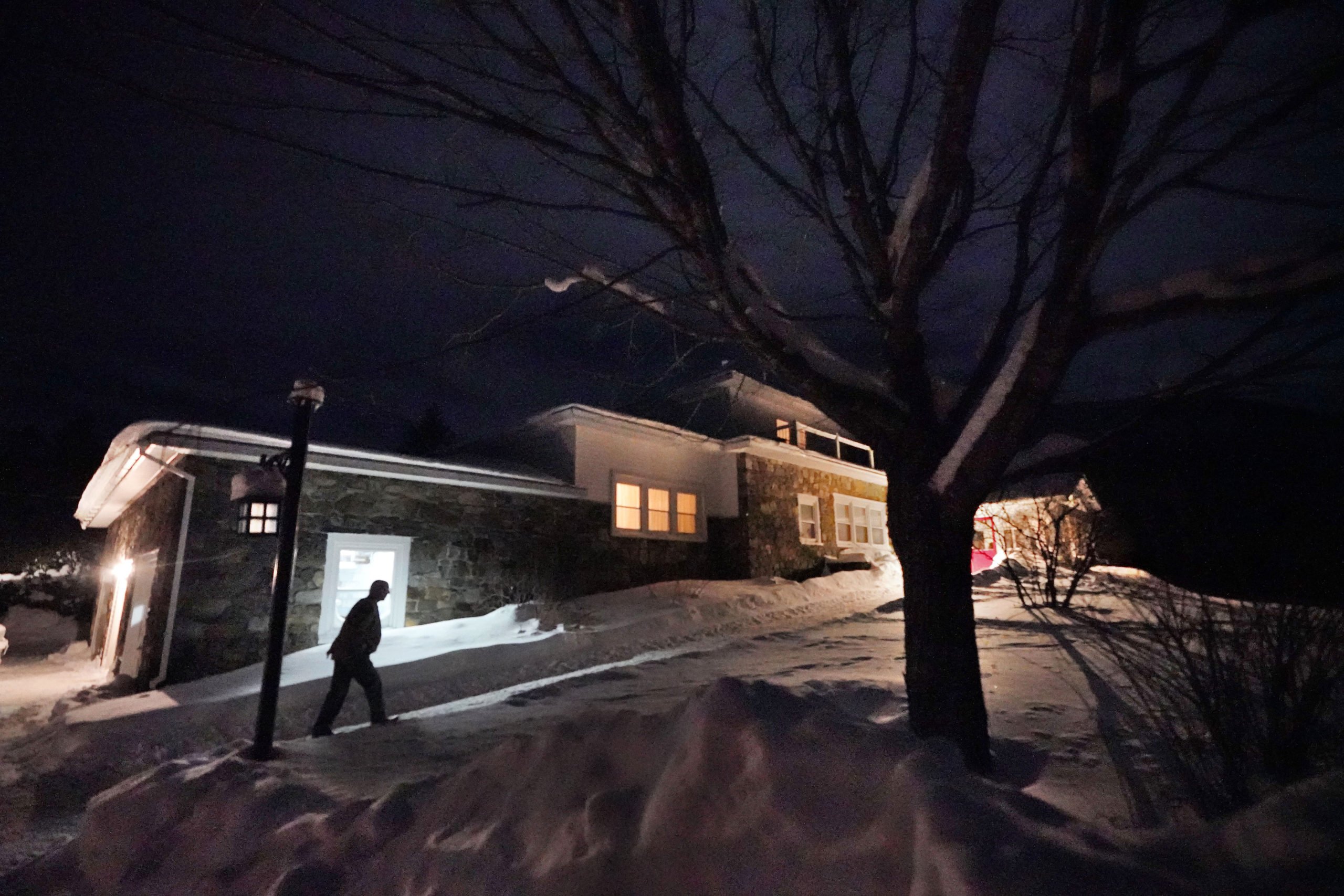 A man arrives Monday evening at the Tillotson House where six voters in the hamlet of Dixville Notch, New Hampshire, voted Tuesday in the New Hampshire Republican primary.