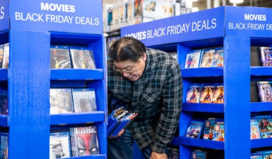 A Black Friday shopper looks at movie deals at a Best Buy store in Emeryville, California, on Nov. 29, 2019.