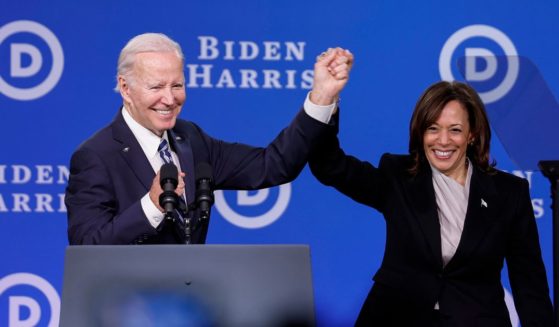 President Joe Biden and Vice President Kamala Harris hold hands onstage after speaking at the Democratic National Committee winter meeting in Philadelphia on Feb. 3, 2023.