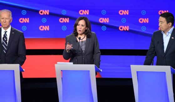 Andrew Yang, right, appeared with fellow Democratic presidential candidates Joe Biden, left, and Kamala Harris in July 2019.