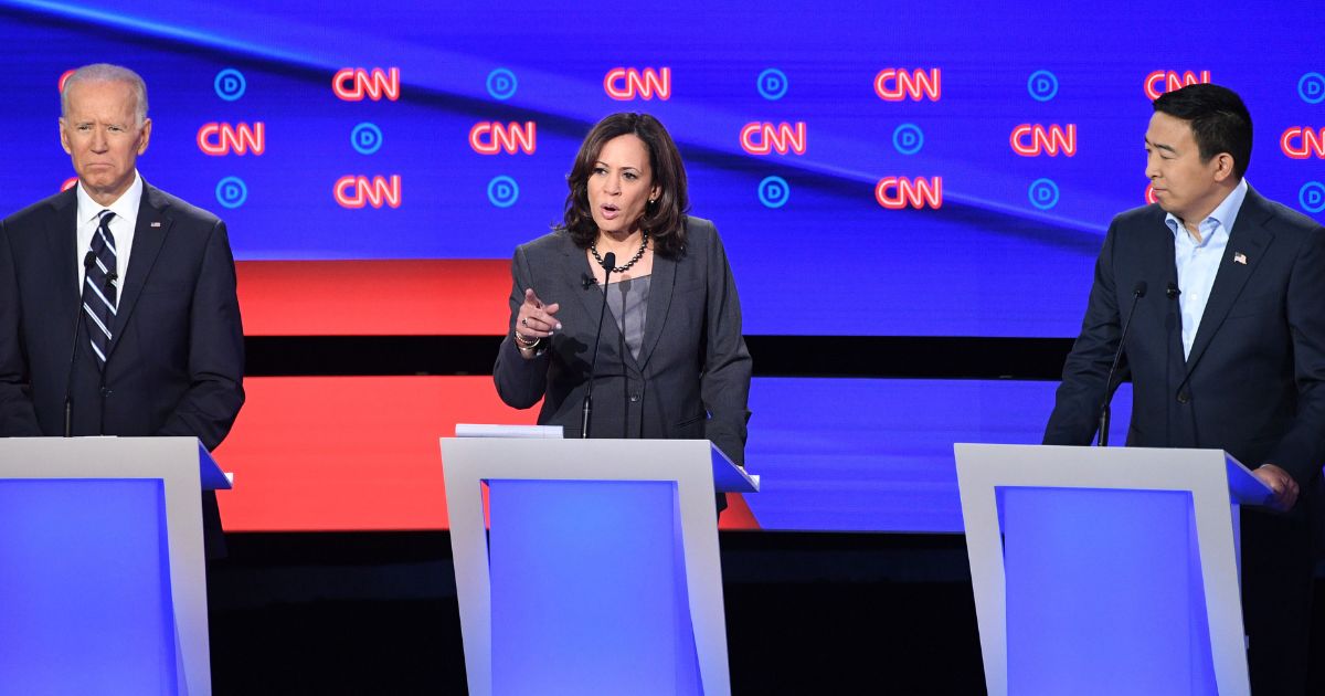 Andrew Yang, right, appeared with fellow Democratic presidential candidates Joe Biden, left, and Kamala Harris in July 2019.