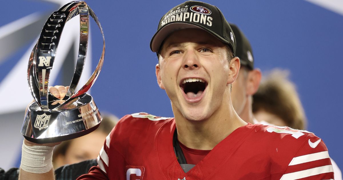San Francisco 49ers quarterback Brock Purdy holds up the George Halas Trophy after defeating the Detroit Lions in the NFC Championship Game in Santa Clara, California, on Sunday.