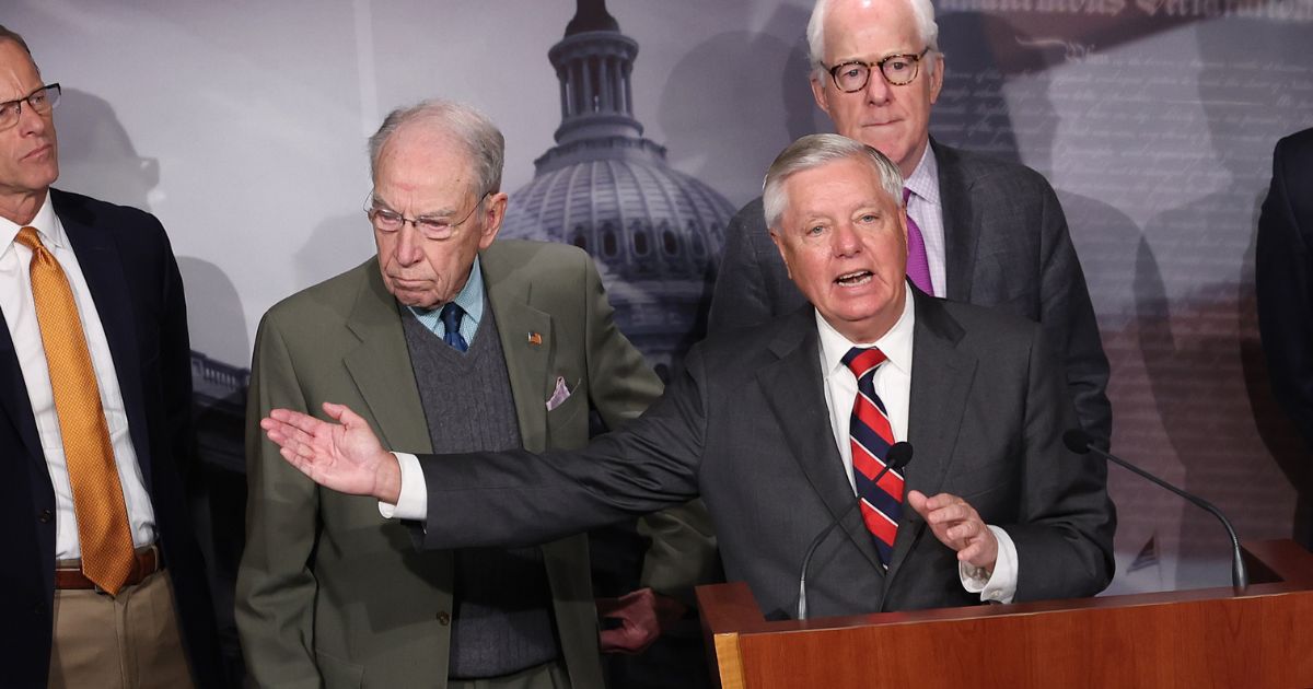 Sen. Lindsey Graham, joined by Sen. Chuck Grassley, left, speaks at a news conference at the U.S. Capitol on Dec. 7, 2023, in Washington, D.C.