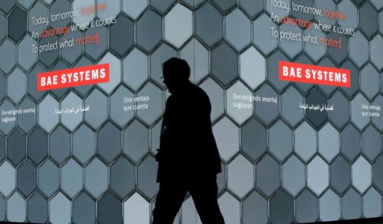 A man walks past a screen in the BAE Systems chalet at the Farnborough Airshow in Farnborough, England, July 16, 2018. China announced sanctions Sunday on five American defense-related companies in response to U.S. arms sales to Taiwan and U.S sanctions on Chinese companies and individuals.