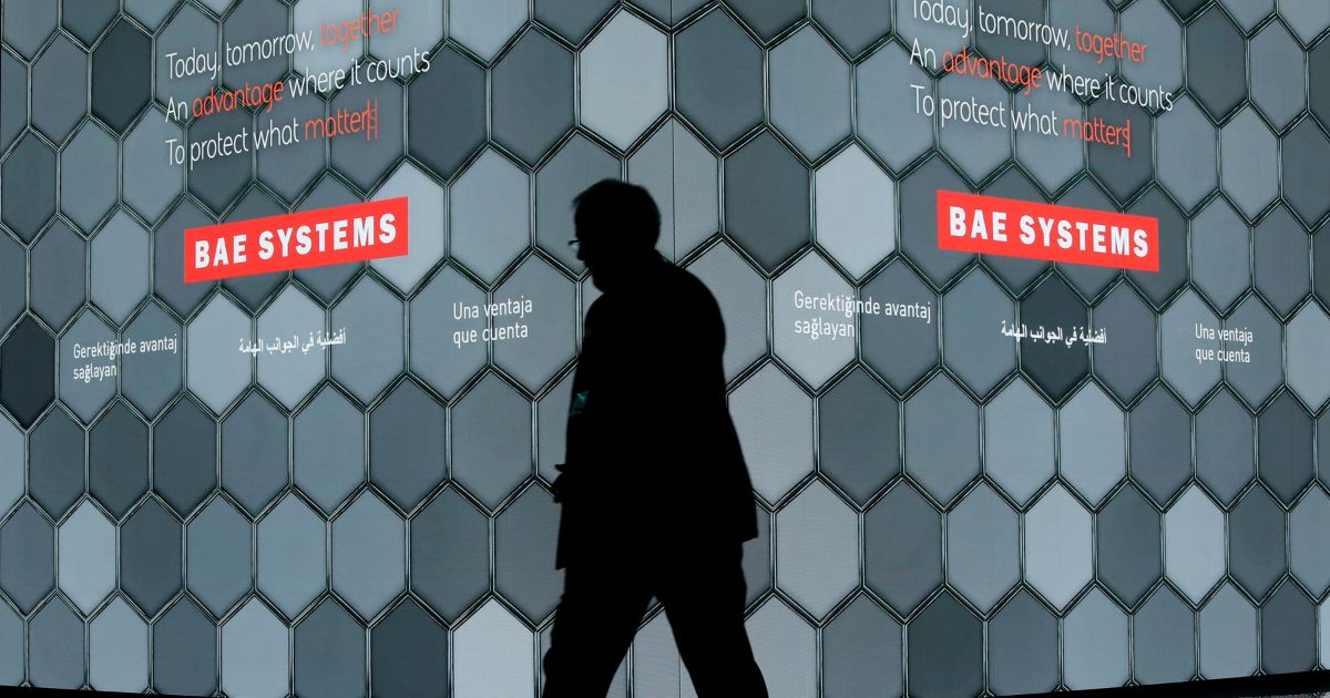 A man walks past a screen in the BAE Systems chalet at the Farnborough Airshow in Farnborough, England, July 16, 2018. China announced sanctions Sunday on five American defense-related companies in response to U.S. arms sales to Taiwan and U.S sanctions on Chinese companies and individuals.