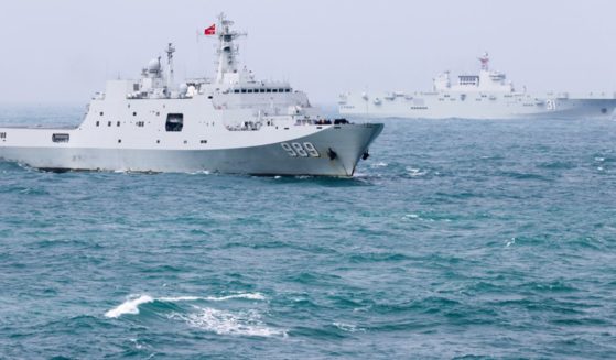 The amphibious dock landing ship Changbaishan and the amphibious assault ship Hainan attached to a landing ship flotilla of the Chinese navy steam in formation during a maritime training exercise in late December.