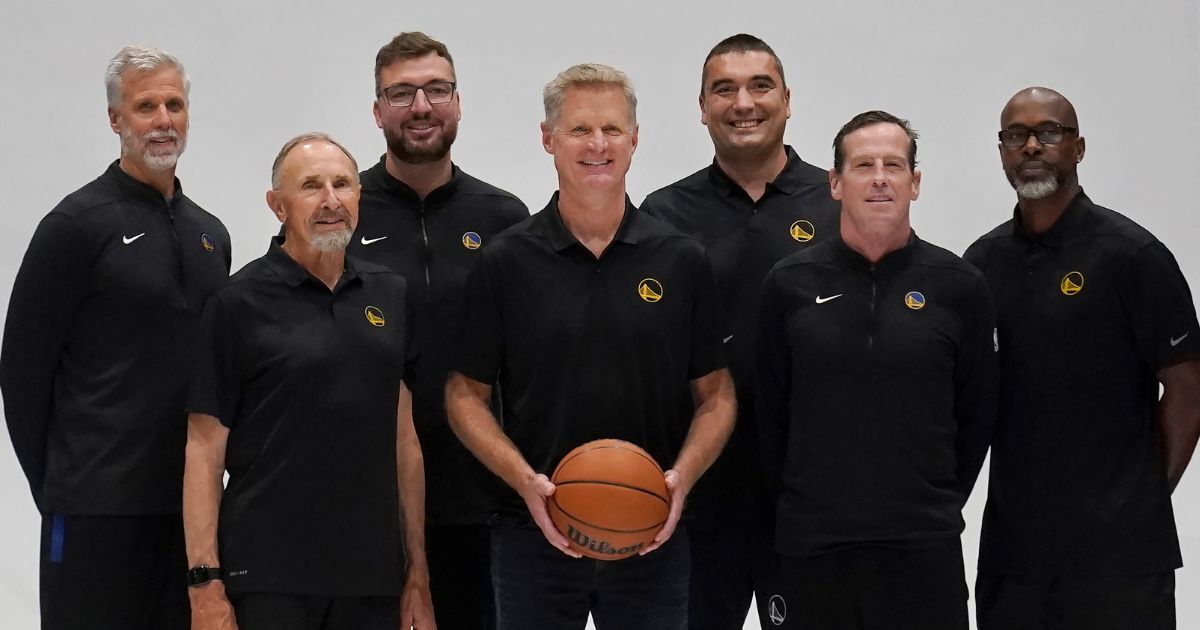 Golden State Warriors head coach Steve Kerr, center, poses for photos with assistants Bruce Fraser, clockwise from top left, Chris DeMarco, Dejan Milojevic, Kris Weems, Kenny Atkinson and Ron Adams during the NBA basketball team's media day in San Francisco, California, on Oct. 2.