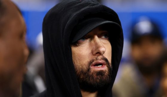 Eminem stands on the field prior to an NFL wild-card playoff football game between the Detroit Lions and the Los Angeles Rams in Detroit, Michigan, on Jan. 14.