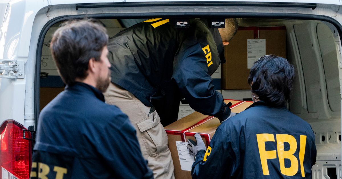 Federal agents load a vehicle with evidence boxes taken from a property related to Russian oligarch Oleg Deripaska, in New York on Oct. 19, 2021.