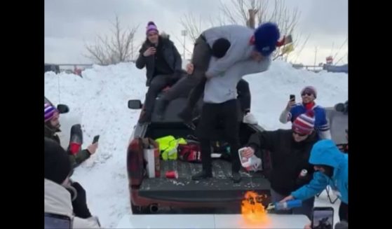 A Detroit Lions fan catches fire while tailgating with Bills fans in Buffalo on Sunday.