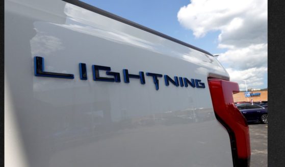 A 2023 Ford F-150 Lightning EV is offered for sale at Golf Mill Ford on July 18, 2023, in Niles, Illinois. Ford announced that it is slashing production of the Lightning truck and shifting hundreds of workers to assembly lines for gas-powered models.