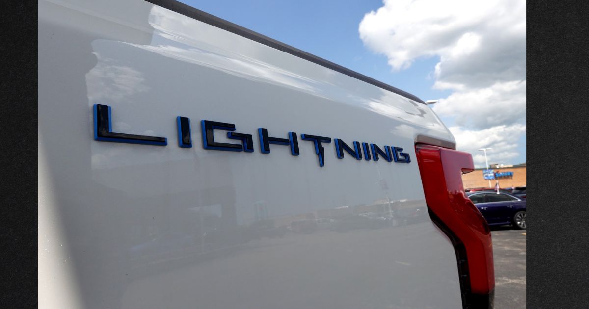 A 2023 Ford F-150 Lightning EV is offered for sale at Golf Mill Ford on July 18, 2023, in Niles, Illinois. Ford announced that it is slashing production of the Lightning truck and shifting hundreds of workers to assembly lines for gas-powered models.