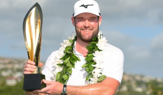 Grayson Murray of the United States poses with the trophy after winning the Sony Open in Honolulu, Hawaii, on Jan. 14.