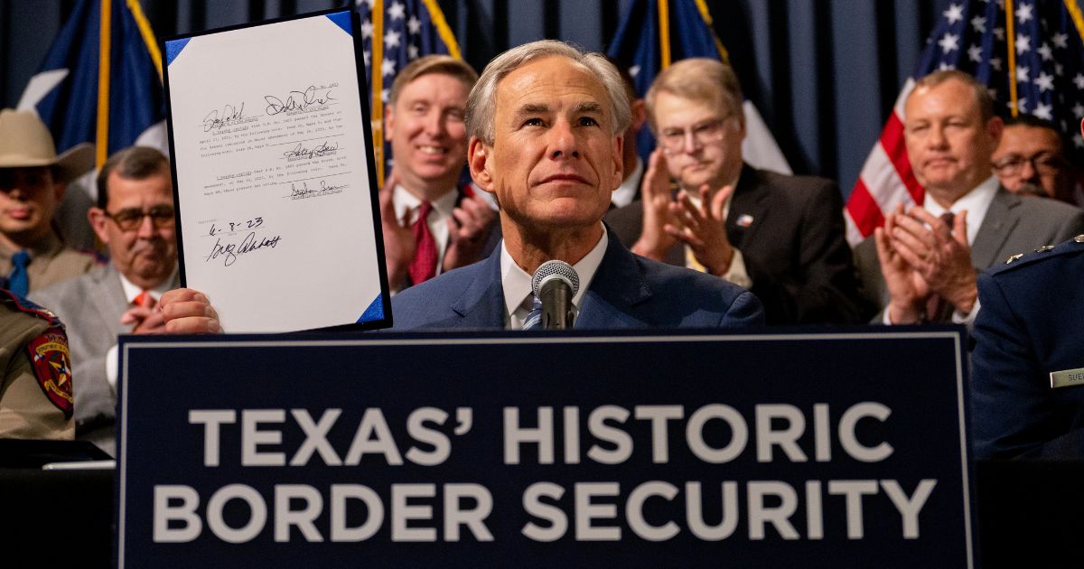 Texas Gov. Greg Abbott displays a signed bill designated towards enhancing border security along the Texas-Mexico border during a news conference at the Texas State Capitol in Austin, Texas, on June 8.