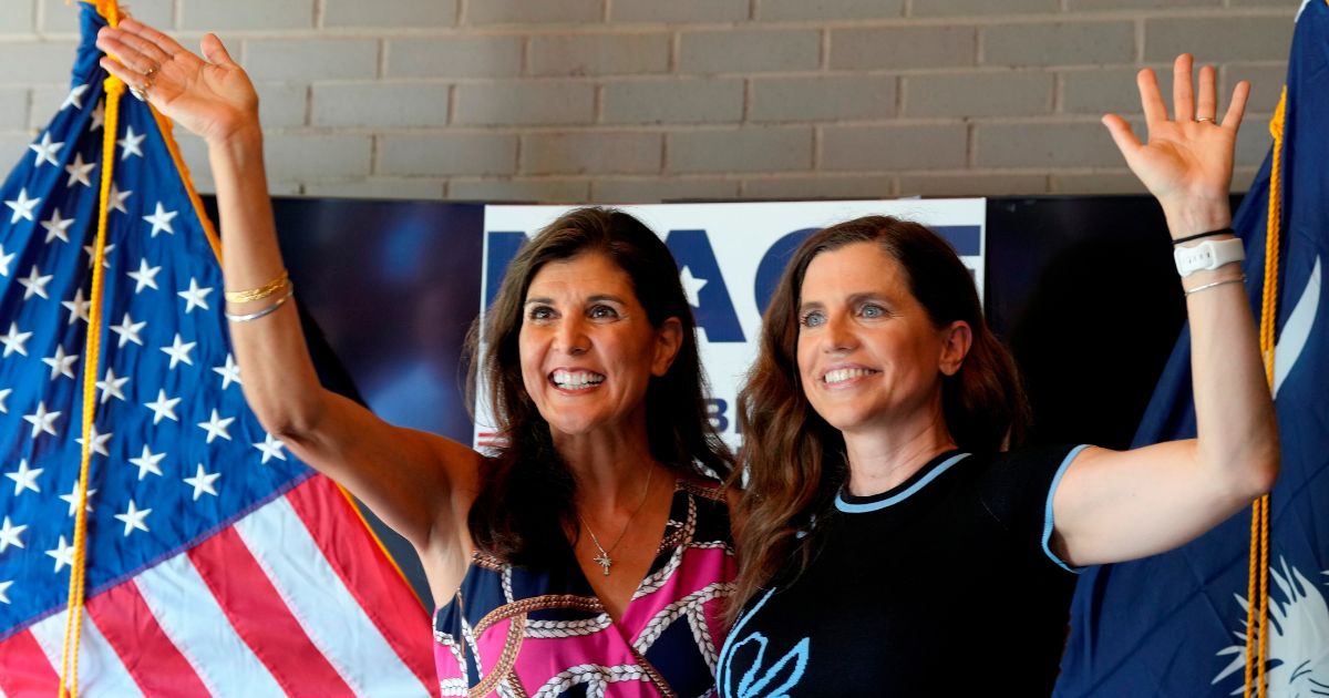 Former South Carolina Gov. Nikki Haley, left, cheers alongside Rep. Nancy Mace, right, during a campaign rally in Summerville, South Carolina, on June 12, 2022.