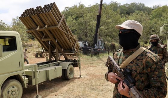 Hezbollah terrorists stand near a multiple rocket launcher in the southern Lebanese village of Aaramta on May 21.