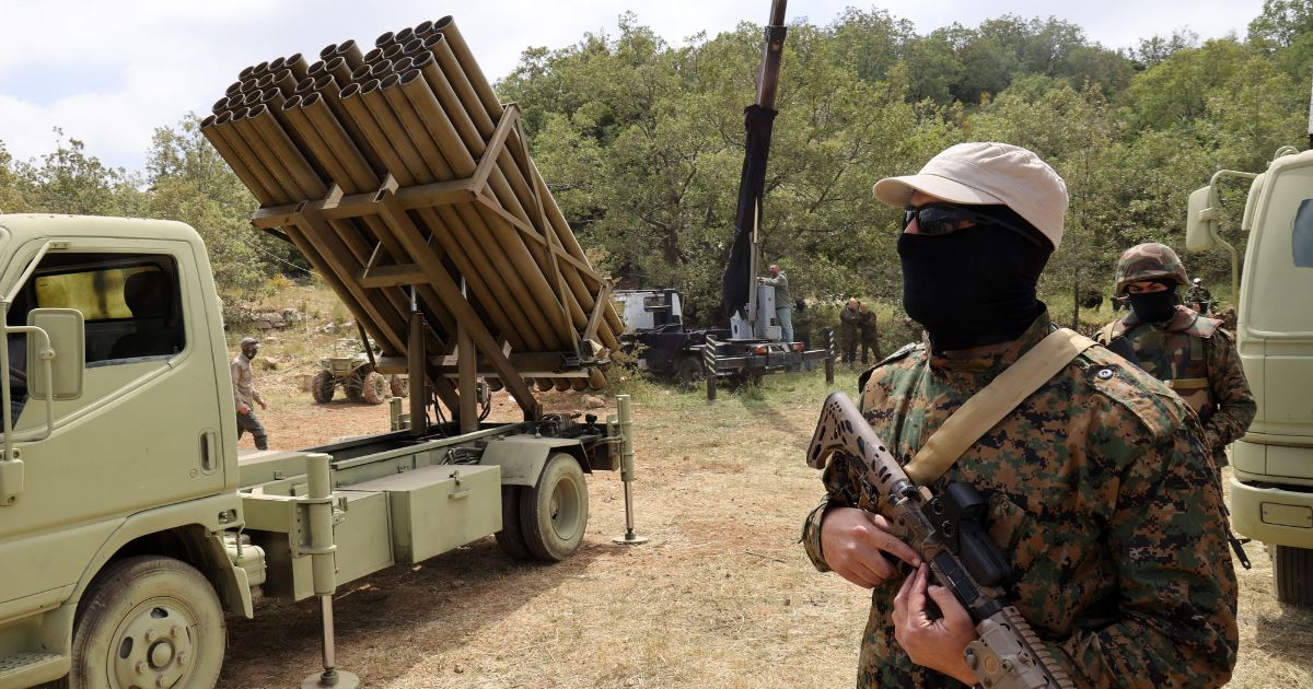 Hezbollah terrorists stand near a multiple rocket launcher in the southern Lebanese village of Aaramta on May 21.