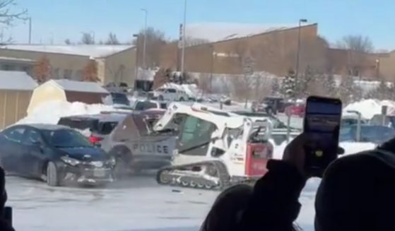 Witnesses shot videos with their cell phones as the Bobcat scooted around the snowy parking lot and rammed a police cruiser.