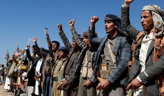 Houthi fighters and tribesmen stage a rally against U.S. and U.K. strikes on Houthi-run military sites near Sanaa, Yemen, on Sunday.