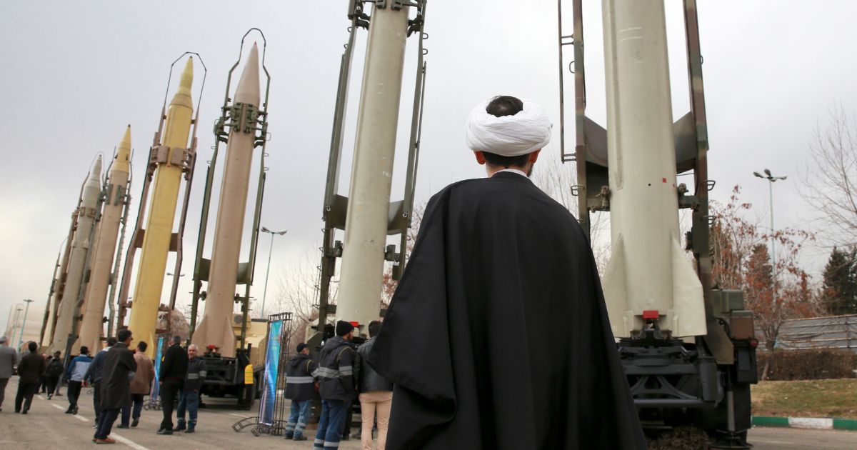 An Iranian clergyman looks at domestically built surface to surface missiles displayed by the Iranian Revolutionary Guard in a 2019 file photo. Iran’s Revolutionary Guard has reportedly been in Yemen assisting rebels in attacks against Israel and its allies -- including the U.S.