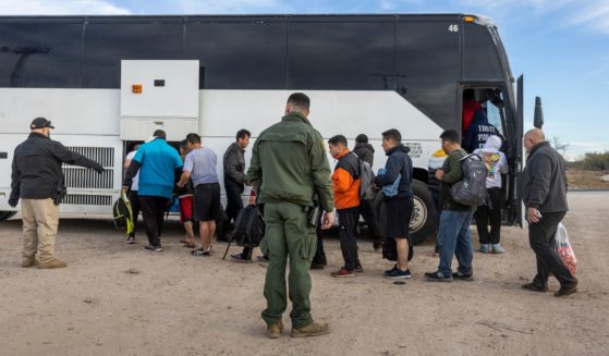 A group of illegal immigrants wait to board a U.S. Customs and Border Protection bus after illegally crossing the U.S.-Mexico border in Eagle Pass, Texas, on Jan. 7.