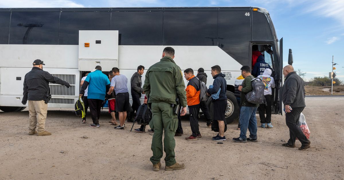 A group of illegal immigrants wait to board a U.S. Customs and Border Protection bus after illegally crossing the U.S.-Mexico border in Eagle Pass, Texas, on Jan. 7.