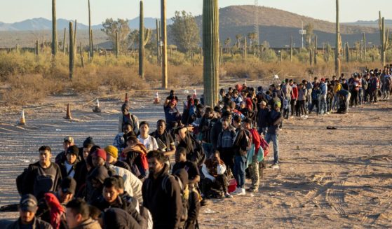 Illegal immigrants line up at a remote U.S. Border Patrol processing center after crossing the U.S.-Mexico border into Lukeville, Arizona, on Dec. 7.