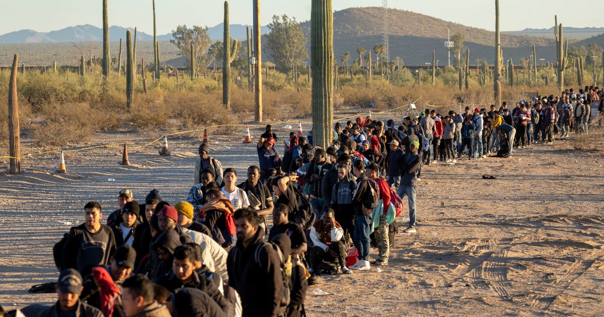 Illegal immigrants line up at a remote U.S. Border Patrol processing center after crossing the U.S.-Mexico border into Lukeville, Arizona, on Dec. 7.