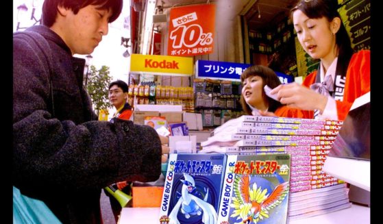 A Japanese customer purchasing a second generation Pokémon game.