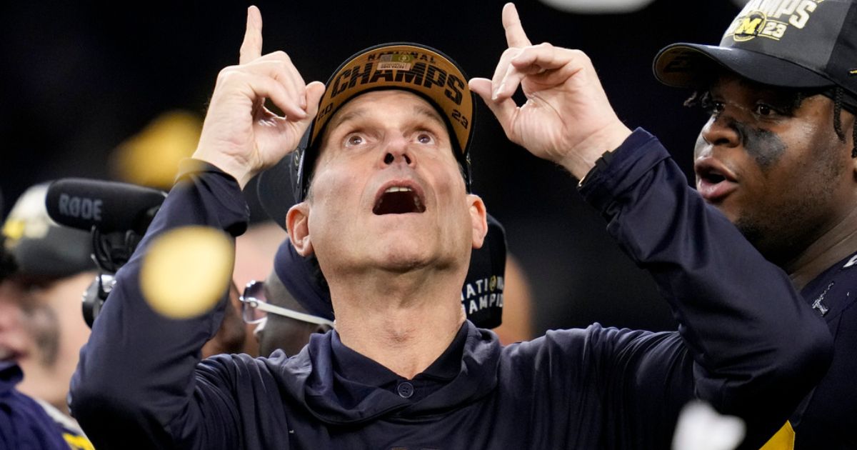 Michigan head coach Jim Harbaugh celebrates after winning the national championship NCAA college football playoff game, Jan. 8, in Houston.