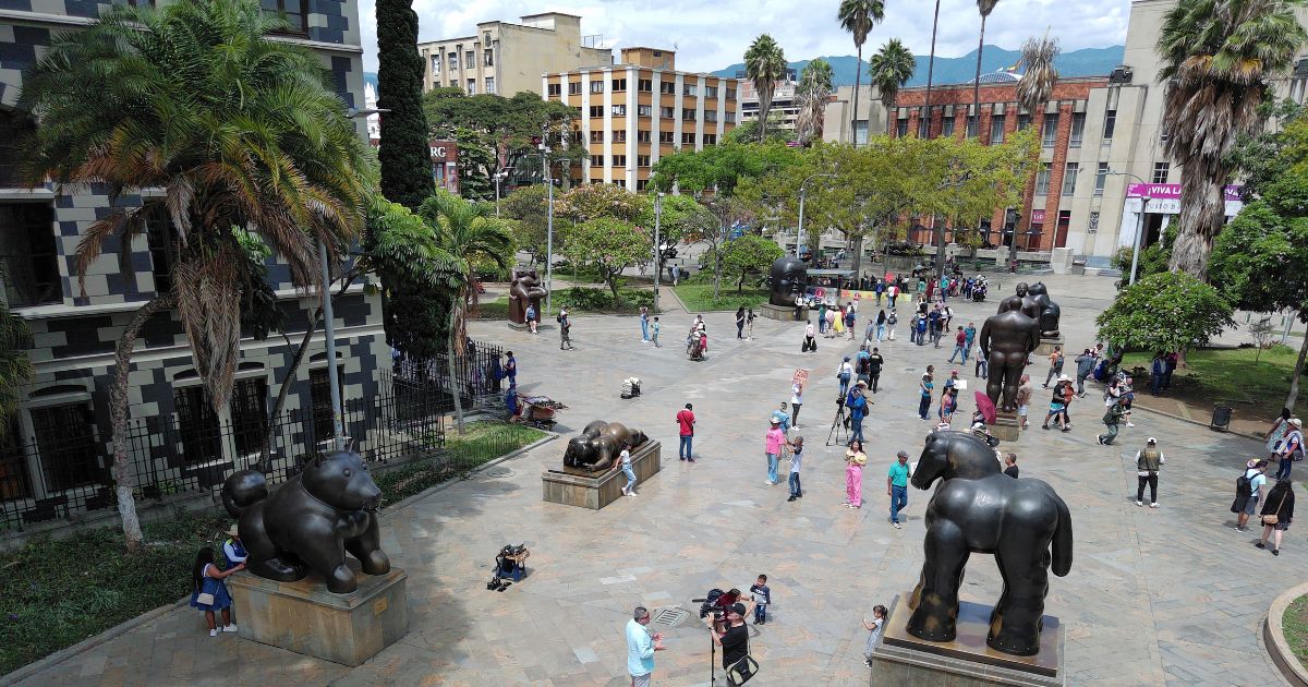 People walk past sculptures at Botero Park in Medellin, Columbia, on Sept. 15. The U.S. Embassy in Colombia has issued a travel warning after eight "suspicious deaths" of Americans in the city.