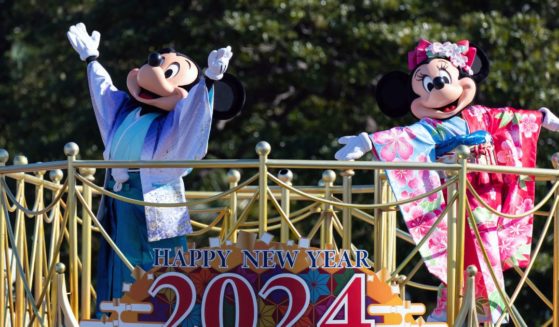 Actors dressed as Walt Disney characters Mickey Mouse (L) and Minnie Mouse (R) perform during the Tokyo Disneyland New Year Parade 2024 at Tokyo Disneyland on Monday.