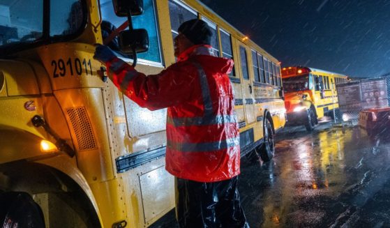 Nearly 2,000 migrants are evacuated by school buses from tents at Floyd Bennett Field to a local high school in preparation for a storm with estimated wind speeds to be more than 70 mph on January 9 in the Brooklyn borough of New York City. More than 100,000 migrants have arrived in New York City over the last year.