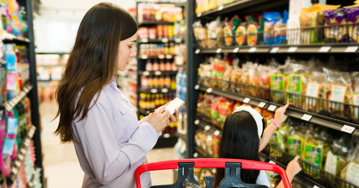 A stock photo shows a woman and her daughter grocery shopping.