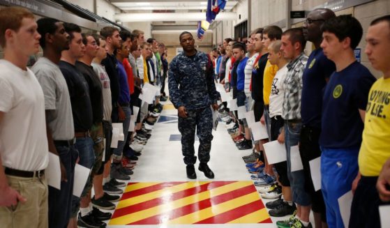 Navy Recruit Division Commander Petty Officer Lewis Dunn, center, inspects a busload of newly arrived Navy Basic Training recruits in Great Lakes, Illinois, on April 8, 2013.
