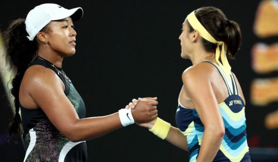 France's Caroline Garcia, right, shakes hands with Japan's Naomi Osaka after their women's singles match on day two of the Australian Open tennis tournament in Melbourne on Monday.